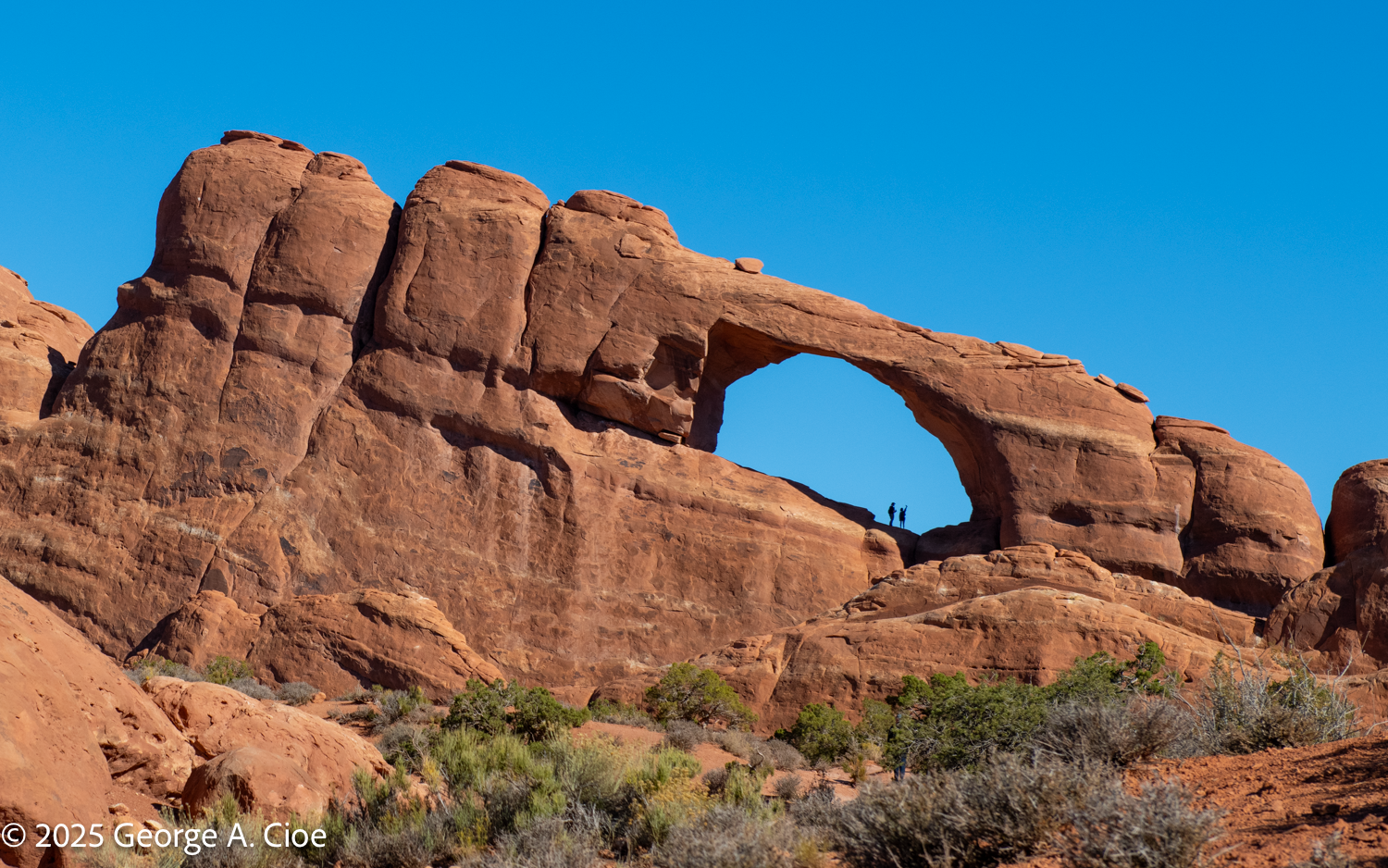 Hikers Steps into Skyline Arch: A Breathtaking Experience